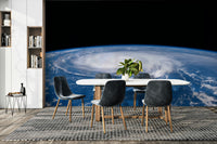 Swirling, dark, and dramatic clouds surround a peaceful circle of clear sky.
