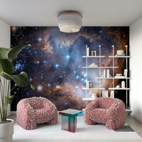 Swirling clouds of gas and dust are visible in vibrant colors like pink, purple, and blue.
