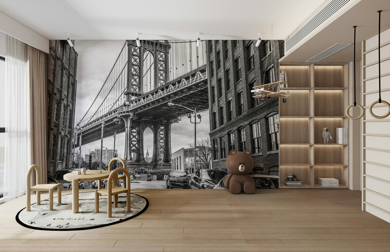 A black and white wall mural featuring the Manhattan Bridge.