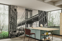 Brick buildings line the sides of the street leading to the bridge.

