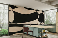 The mural is installed in a calm living room behind a simple, light-colored sofa.


