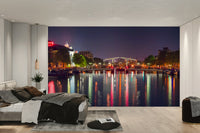 The mural is installed in a calm living room behind a simple, light-colored sofa.

