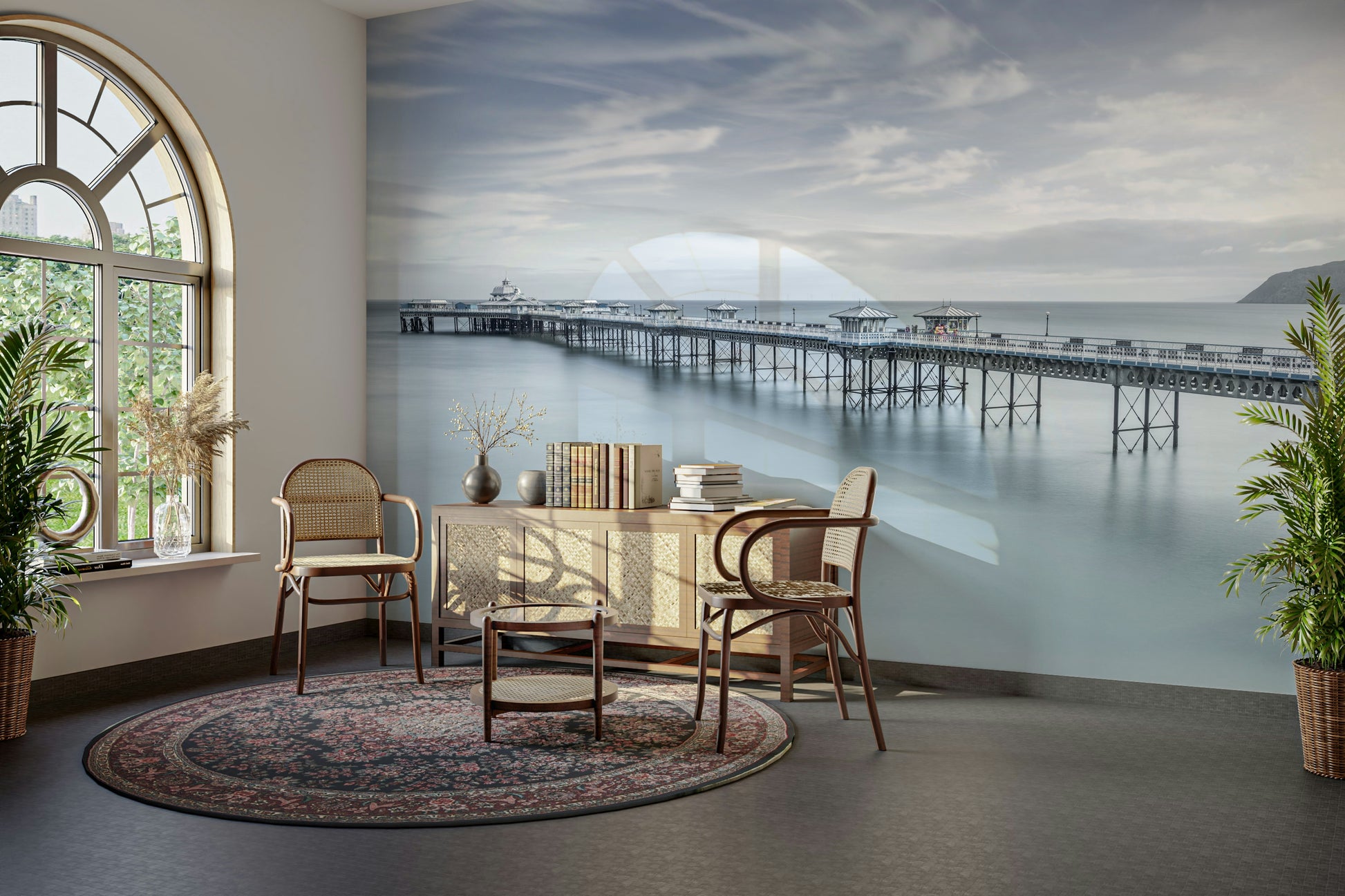 The mural shows a peaceful seascape with a long pier.

