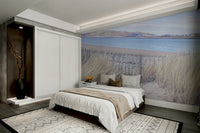 The mural shows a peaceful landscape with cliffs and a sandy beach.

