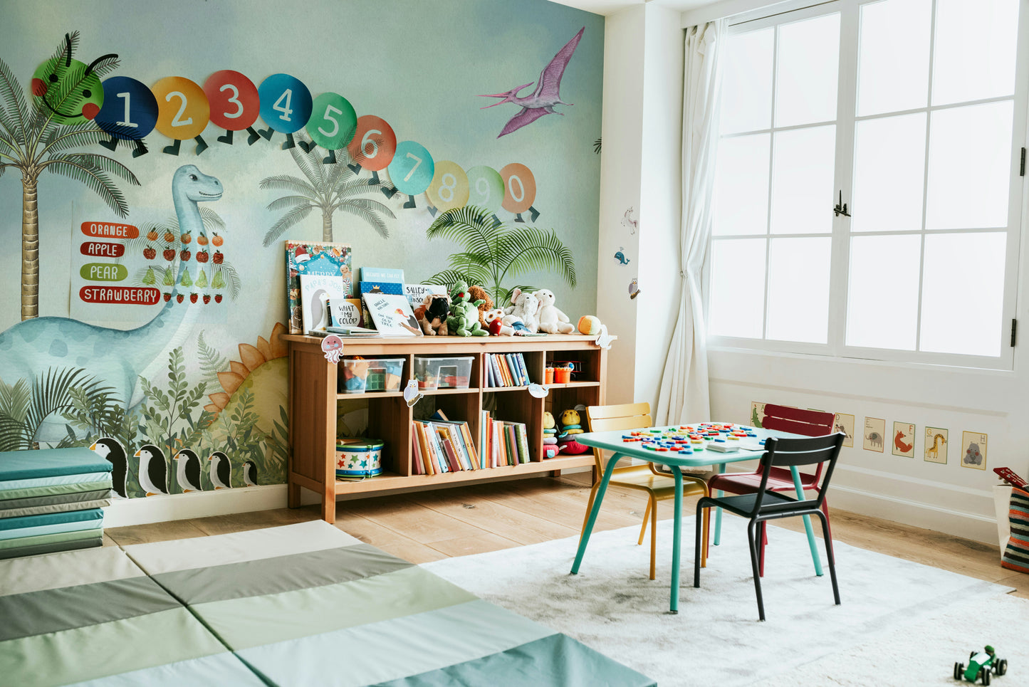 Wall mural with cartoon dinosaurs and a jungle

