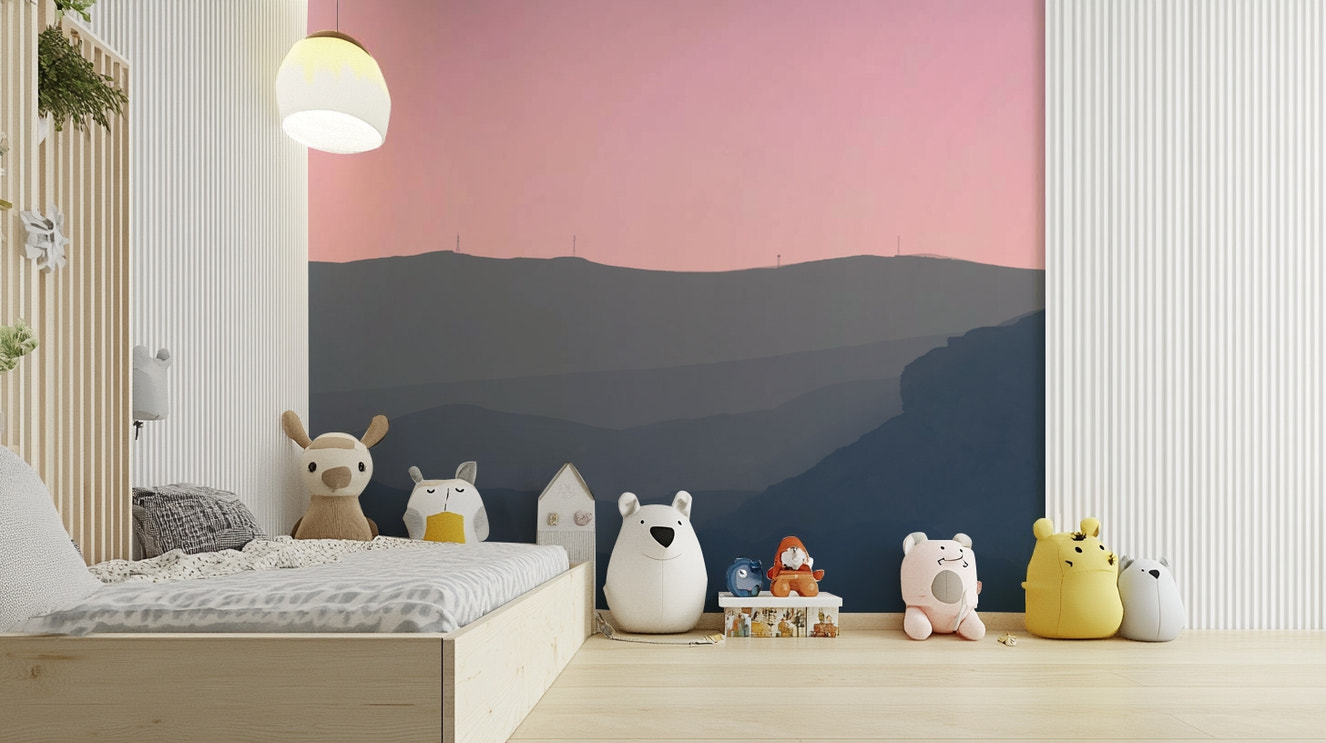 A beautiful, layered mountain landscape with a pink sunset sky.

