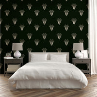 A bedroom with the lush foliage mural behind the headboard.