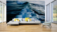 An artistic coastal scene mural on minimalist wallpaper.

