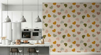 Playful heart shapes in mustard, olive, blush, and beige forming a sweet pattern on this wallpaper.