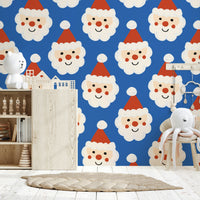 Playful holiday wallpaper with rows of jolly Santa faces wearing red hats on blue.