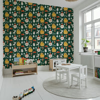 Whimsical holiday wallpaper featuring cabins, candy canes, Santa faces, and seasonal icons on green.