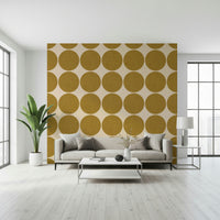 Warm neutral wallpaper with oversized ochre round shapes arranged in rows and columns