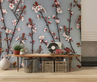 The wallpaper captures cherry blossoms with crisp detailing and warm reddish-brown stems.