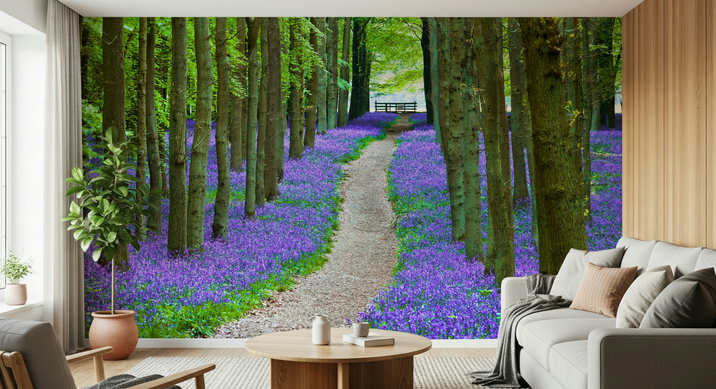 Nature trail wallpaper showcasing a dreamy bluebell-covered forest floor.