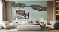 Solitary bench, pristine snow field, charming winter scene wall mural.