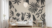 Beige botanical wall mural styling a nursery with flowing charcoal fronds