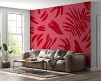Crimson leaf wall mural behind a living room sofa with flowing botanical shapes