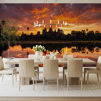 Dining room setup with temple silhouette wall mural and sunset reflection