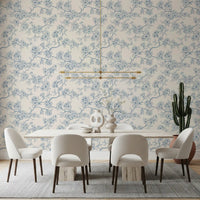 Dining room setup with cherry blossom branch wallpaper in soft blue tones