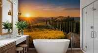 Bathroom wall mural featuring cypress path scenery and warm Tuscan sunset fields