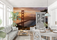 Golden hour bridge reflection wall mural featured across a dining room 