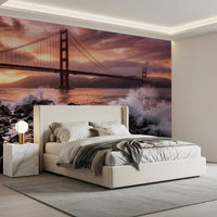 Bedroom wall mural with rocky shoreline waves and bridge sunset backdrop