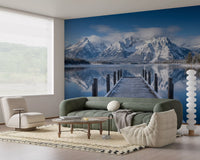 Living room wall mural with alpine snow peaks and reflective lake scene
