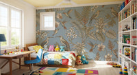 Bird and flower wall mural with tropical leaves on a muted blue base