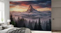 Snowy summit wall mural with forest silhouettes and layered mist below