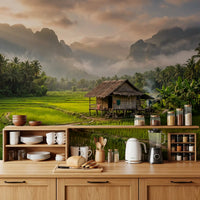 Warm light spreads across this mountain wall mural with green fields