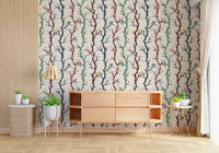 Hallway styled in woodland branches wallpaper with bright birds and leaves