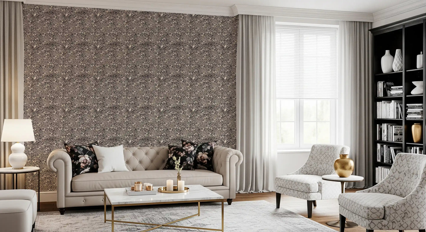 Cream-ivory pebbles float over a dark base on this organic textured wallpaper