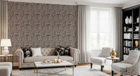 Cream-ivory pebbles float over a dark base on this organic textured wallpaper