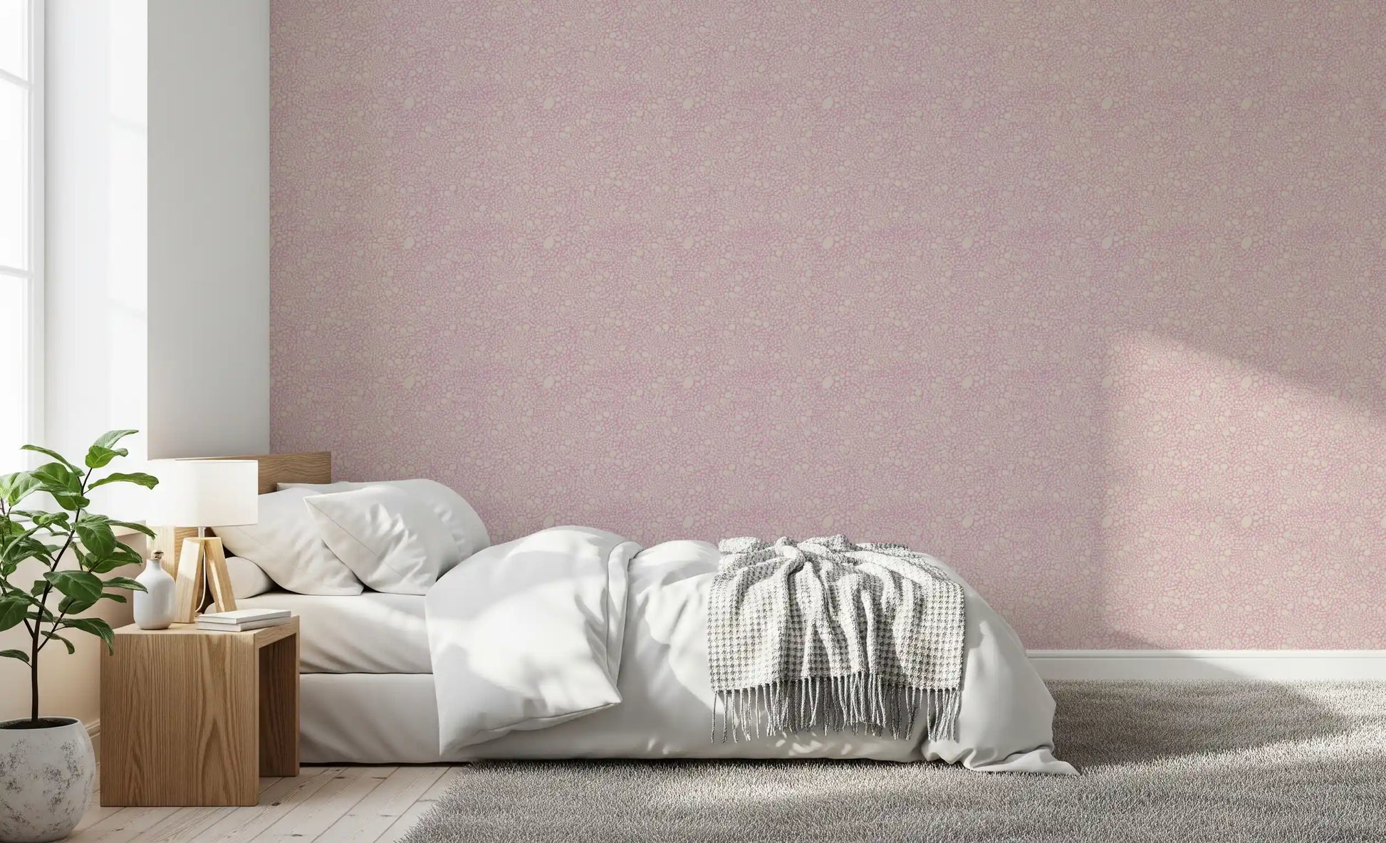 Pastel pink pebble wallpaper spanning this airy bedroom in tonal cream