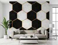 Hexagon wall mural in black, white and gold framing a modern living room space