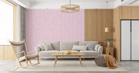 Pastel Living space showing the pink watercolor wallpaper with vertical strokes