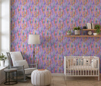 Lively painterly ribbons of orange, green and blue stream across the chromatic flow wallpaper