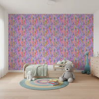 Playful nursery showing the rainbow brushstroke pattern wallpaper across a bright 