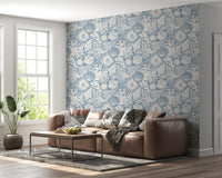 Hazy blue coastal wallpaper along a lounge feature surface in off-white tones
