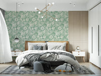 bedroom with boho seashell and coral aqua green wallpaper behind the table