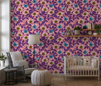 Pink dog rose blooms and blue butterflies layer over purple leaves on this floral wallpaper