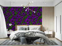 Bedroom backdrop done in purple clematis vine wallpaper with green foliage and deep tones