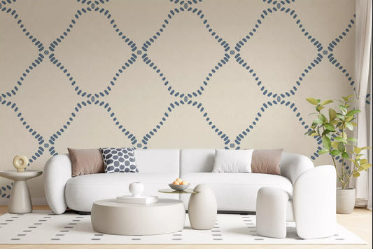 Dotted Lattice wallpaper gives a living room a calm coastal-boho backdrop.
