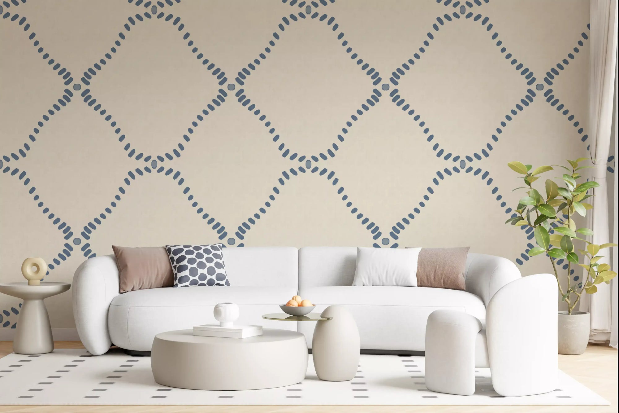 Dotted Lattice wallpaper gives a living room a calm coastal-boho backdrop.
