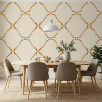 Clusters of gold dabs taper toward each diamond point on this Boho wallpaper.