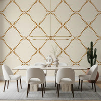 Warm gold diamonds lend a sunny boho note to a dining room in this Lattice wallpaper.