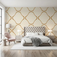 Bedrroom gains warm boho rhythm from this Golden Lattice wallpaper.