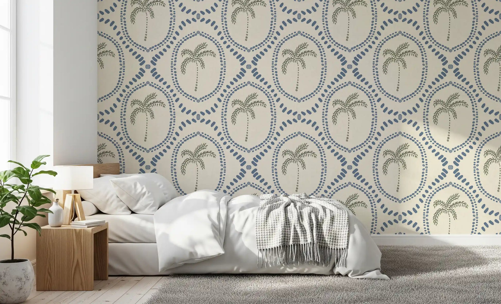 Calm and coastal, this bedroom wears beachy palm oasis wallpaper in blue and green