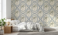 Calm and coastal, this bedroom wears beachy palm oasis wallpaper in blue and green
