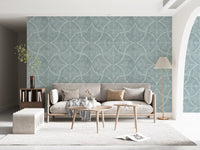 Textured fan motifs anchor a quiet living room in muted blue wallpaper